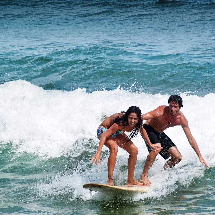 A Couple Has Aquatic Adventures Surfing