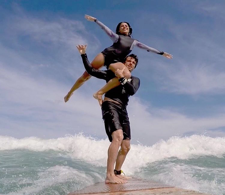 Dedicated Duo Committed To Water Sport Of Tandem Surfing