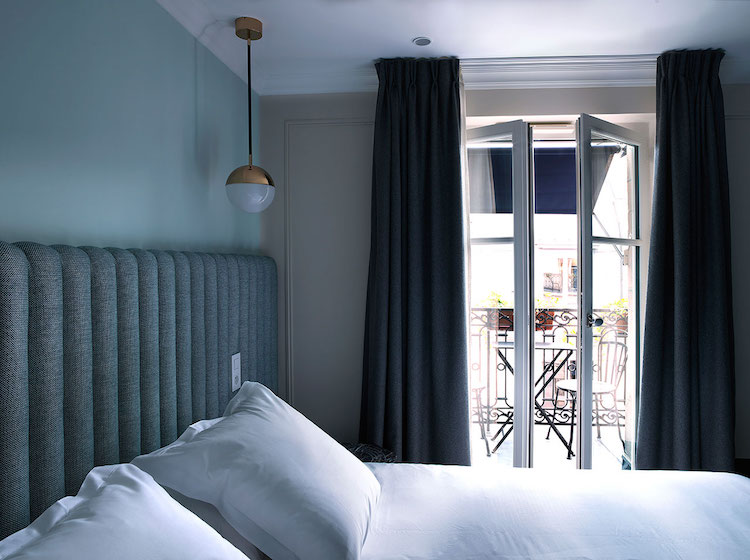 Guest Bedroom In Parisian Hotel With Cast Iron Balconies