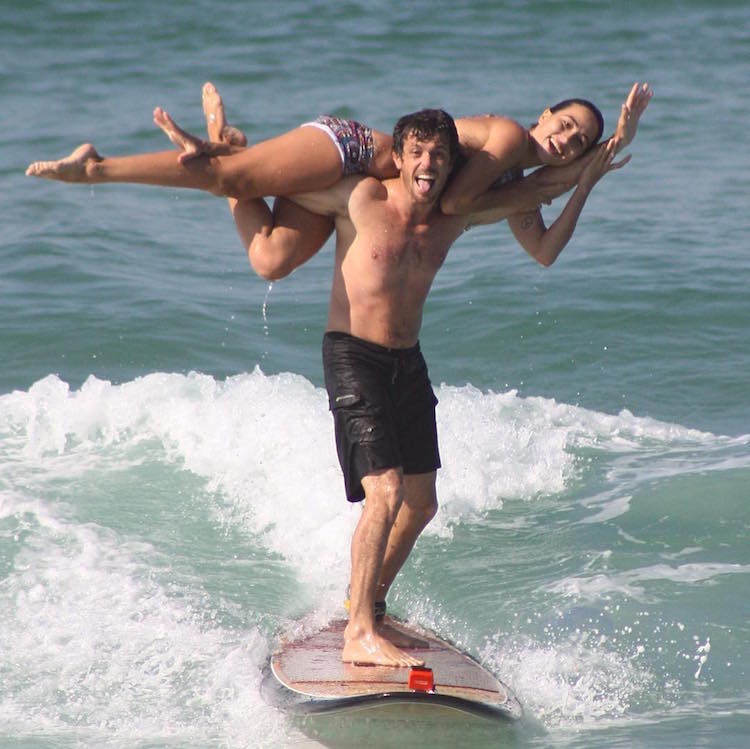 A Couple's Acrobatic Adventures On A Surf Board