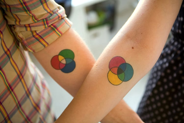 Matching mountain tattoos on a couple.