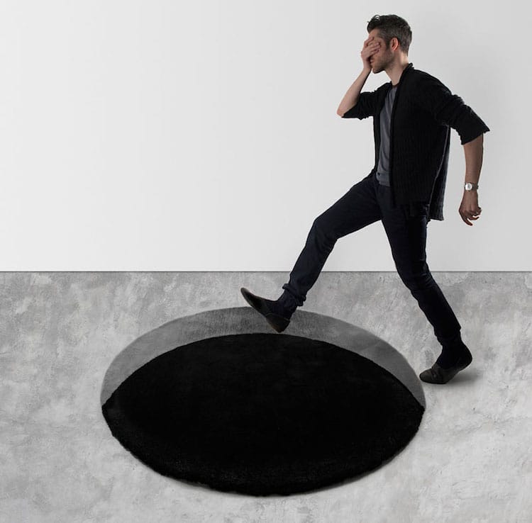 Optical Illusion Rugs Make It Look Like There's a Giant Hole in the Ground eye tricks halloween black hole rug padstyle 