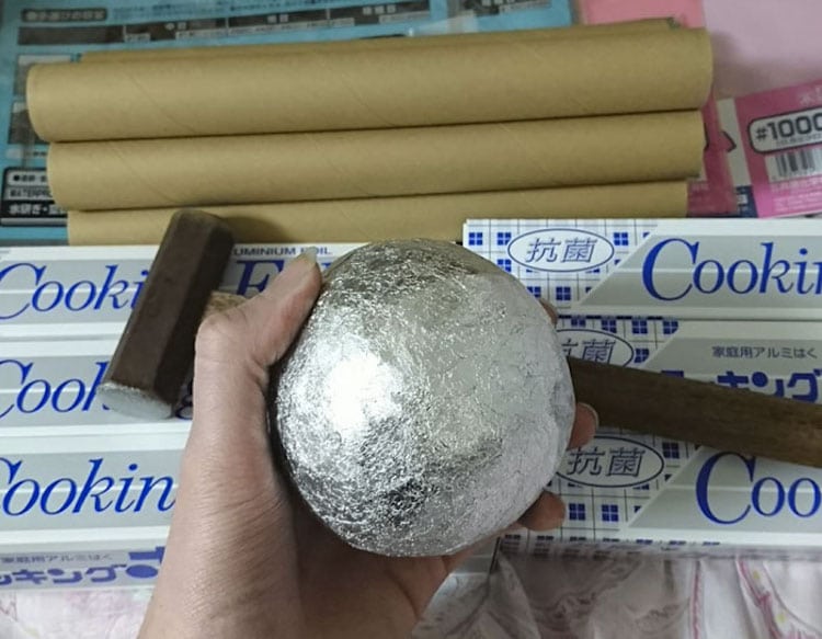 Watch Someone Transform An Aluminum Foil Ball Into A Shiny Orb