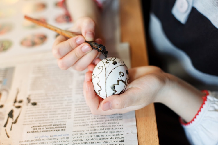 Lviv, Ukraine. 06th Apr, 2023. A young woman makes Easter eggs. A young  woman in traditional Ukrainian clothing makes Easter eggs using ancient  technology. Pysanka is an ancient tradition, one of the