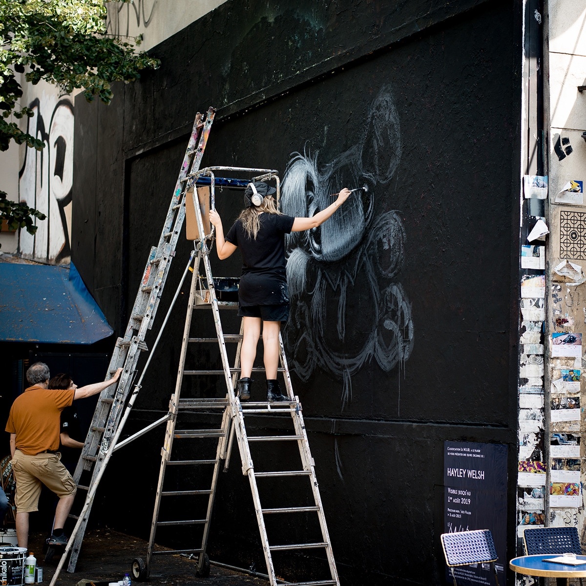 Female Street Artist Painting Mural