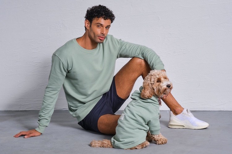 Man and dog wearing matching sweatshirts