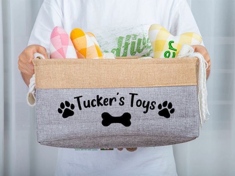 Dog toy basket that says Tucker's Toys on it