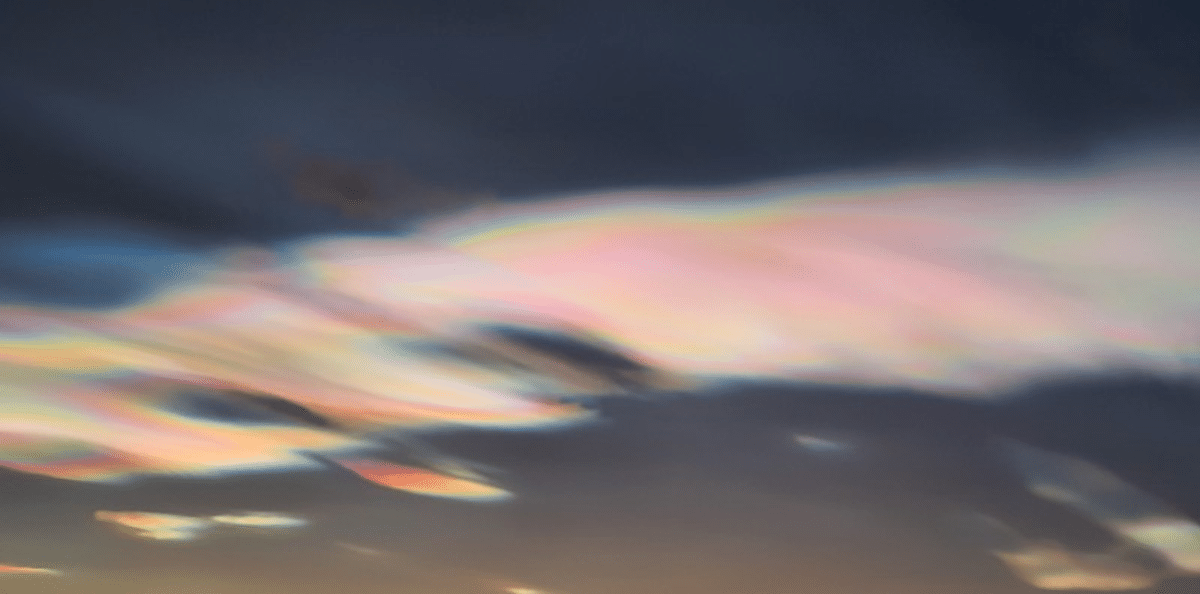 Iridescent Clouds Over Belukha Mountain in Siberia by Svetlana Kazina