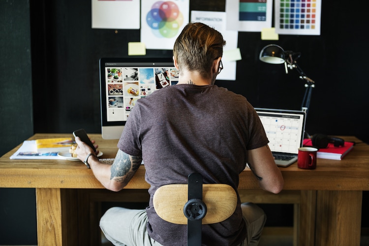 Man Sitting at a Desk and Working from Home