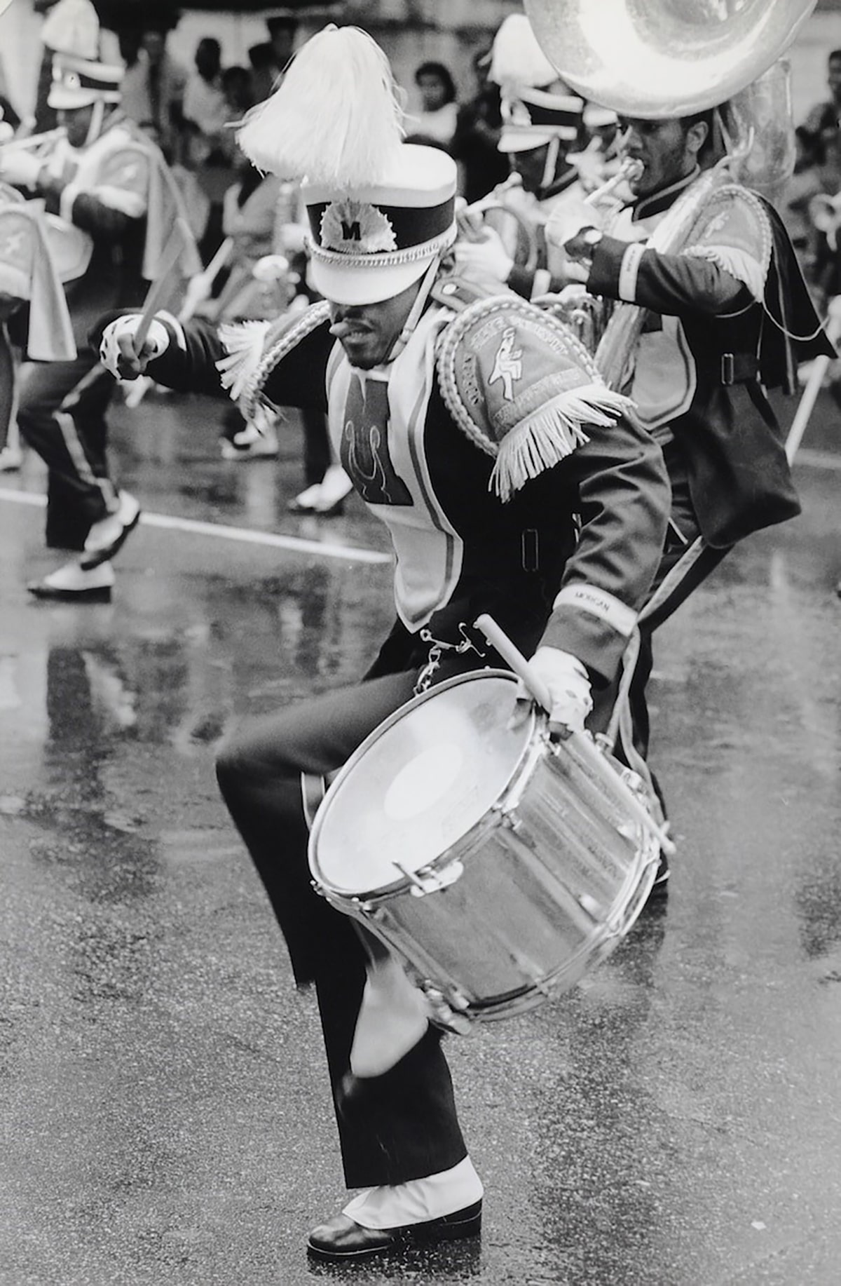 African American marching band member drumming on a snare drum