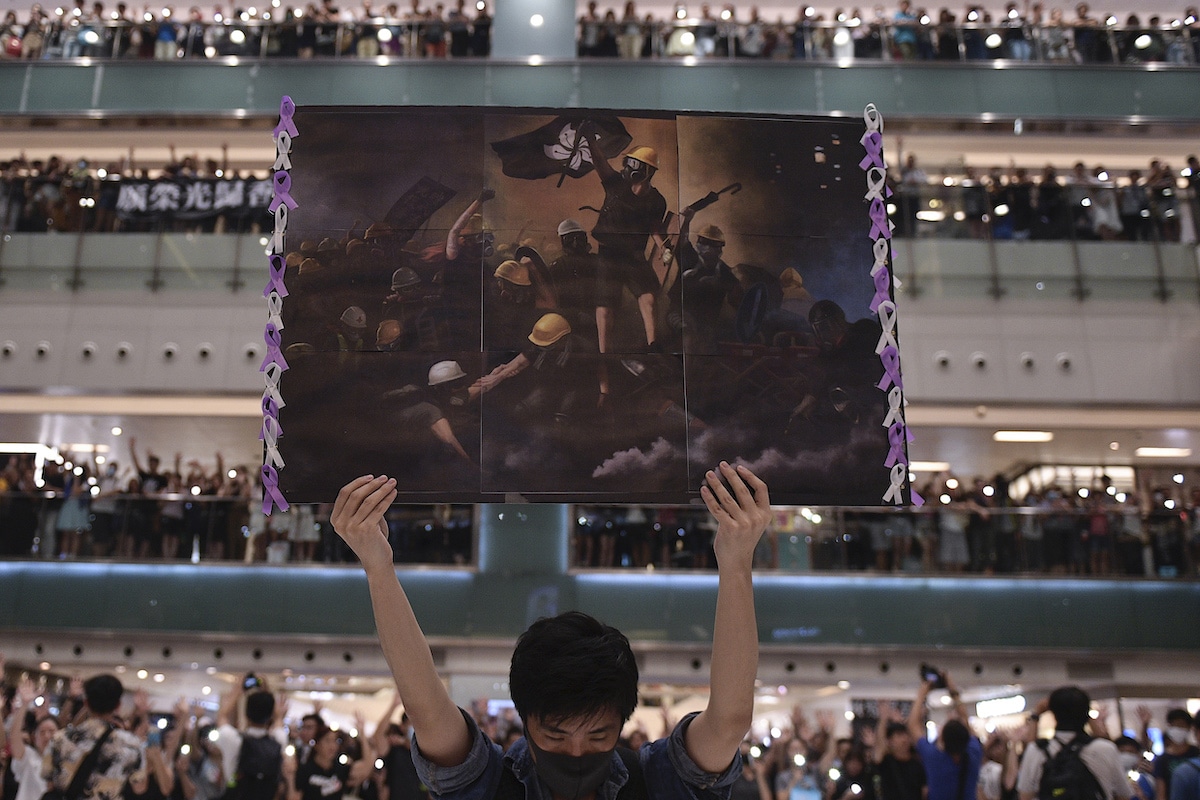 Protester in Hong Kong Holding a Poster