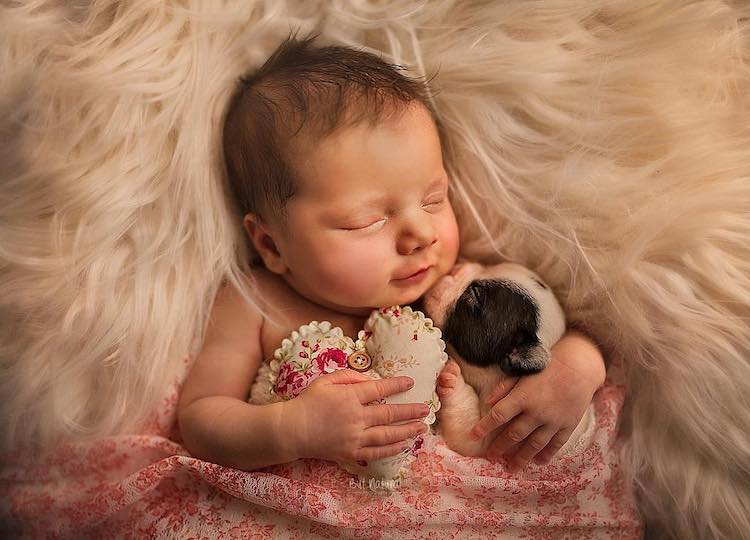 Heartwarming Portraits of Newborn Babies Snuggling With Baby Animals