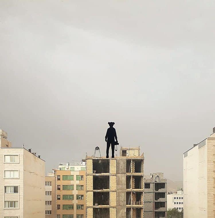 Painted Silhouette of Person Standing on the Roof of a Building