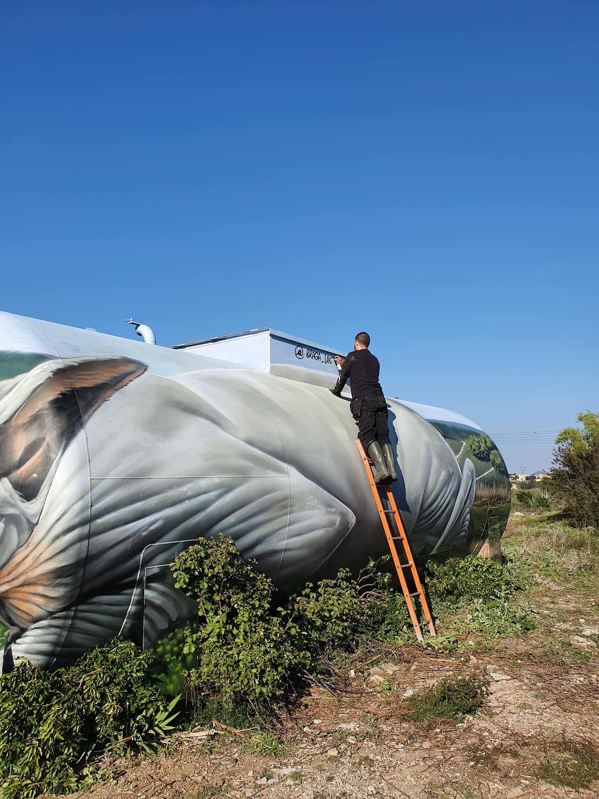 Street Artist Painting a Gas Tank