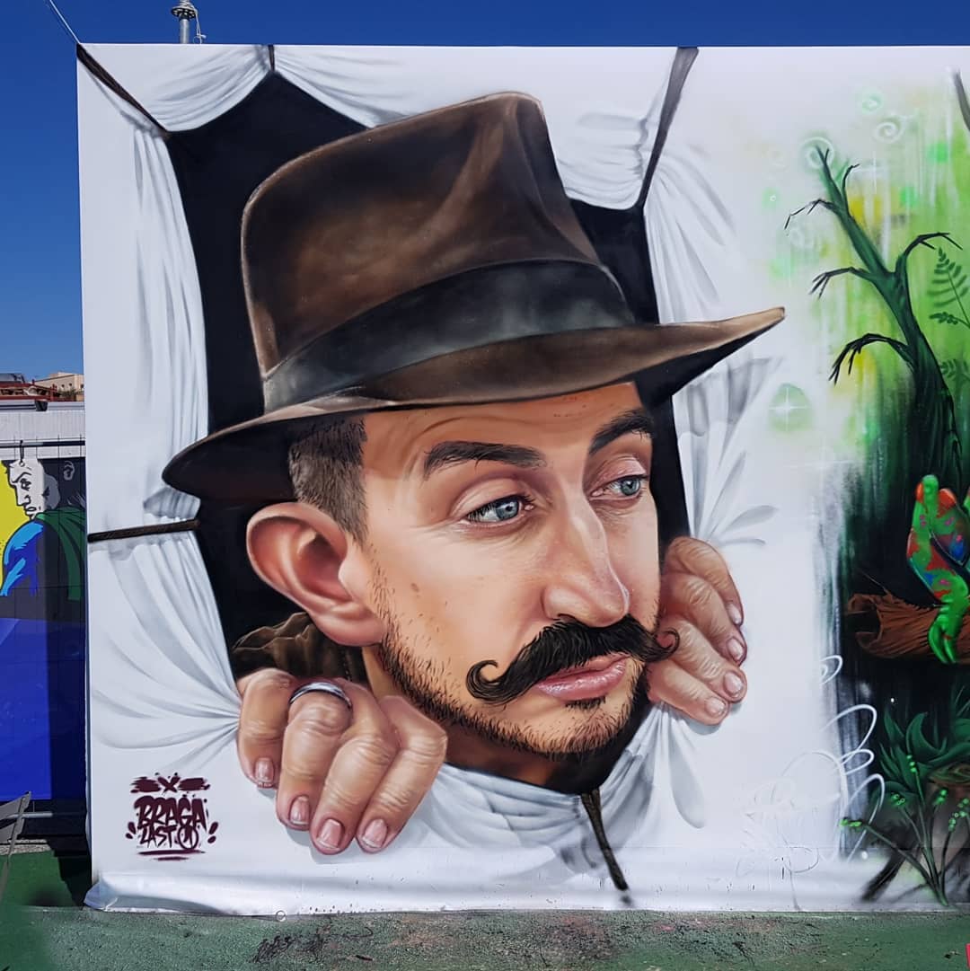 Trompe L'Oeil Painting of Man with Hat Emerging from Wall