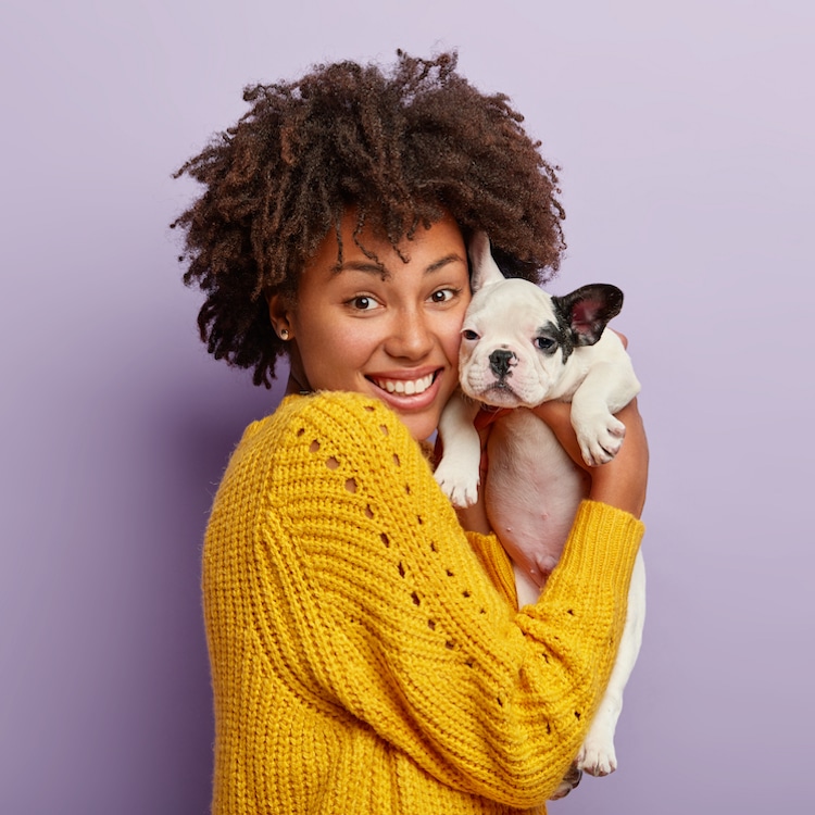 Woman of Color Holding Dog