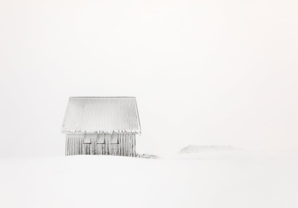 Snow Covered Hut in a Wintery Landscape