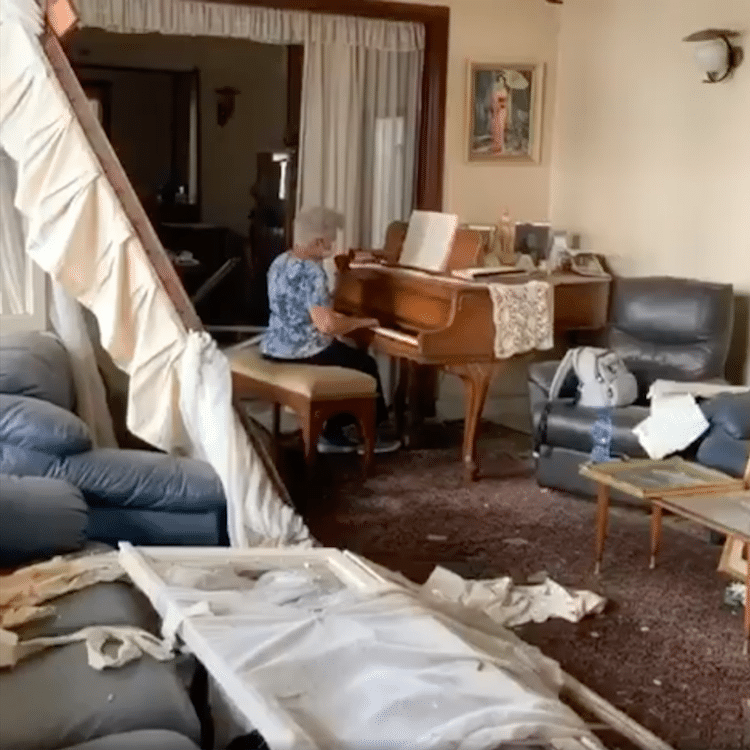 May Abboud Melki playing piano in destroyed home