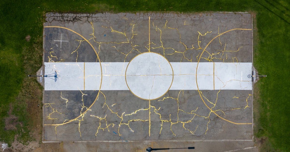 Artist Uses Japanese Art of Kintsugi to Fill in Basketball Court’s Cracks With Gold