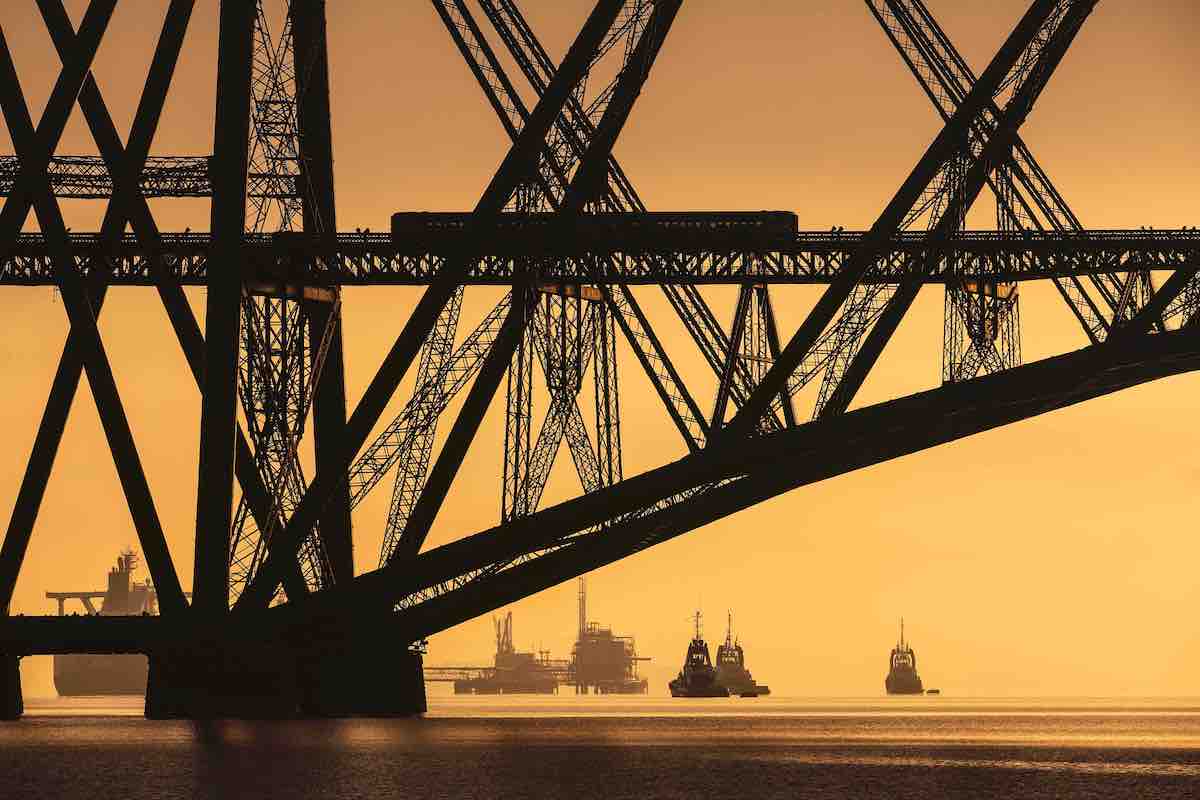 Steel Bridge at Sunset with Boats Crossing