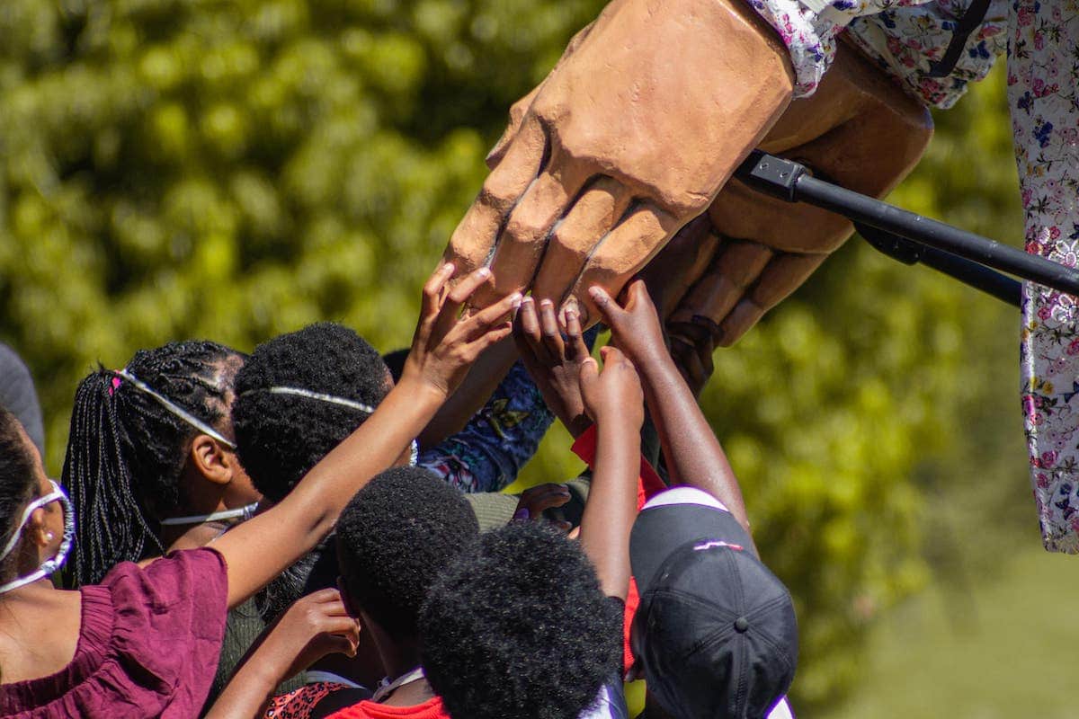 Children Touching Little Amal's Hand