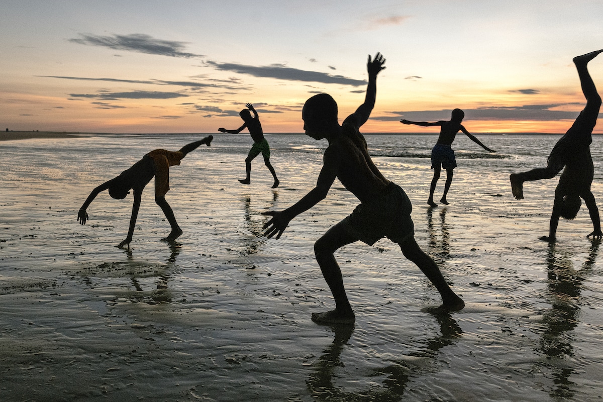 Children Doing Cartwheels on the Beach in Madagascar by Steve McCurry