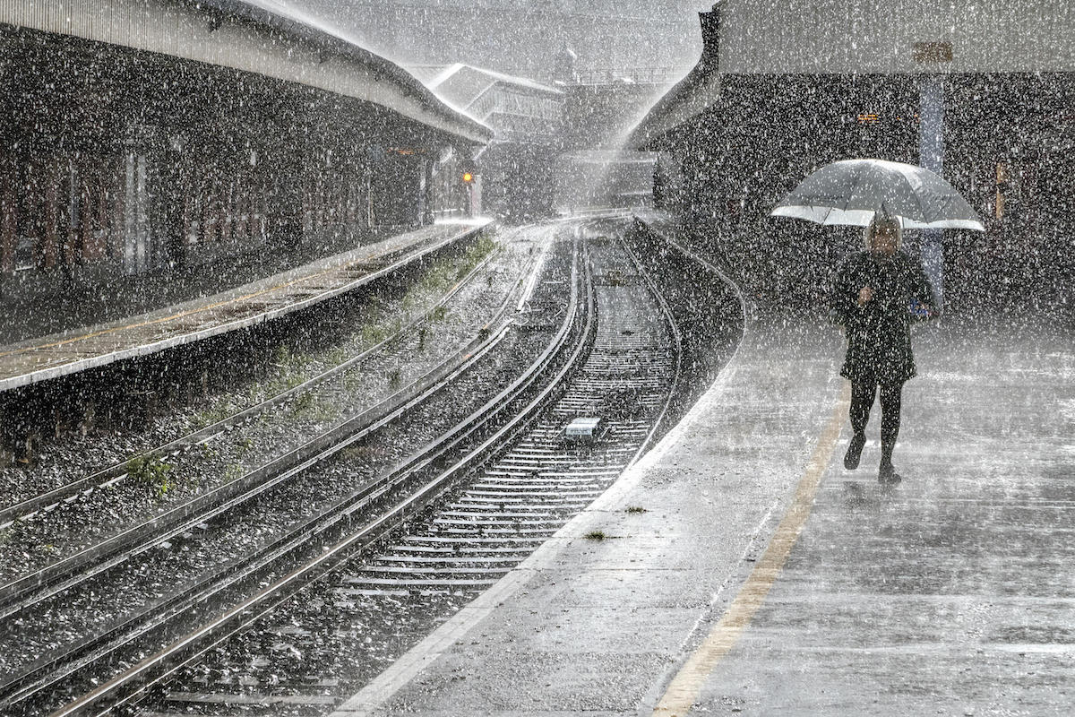 Woman Walking in the Rain at Waterloo Station
