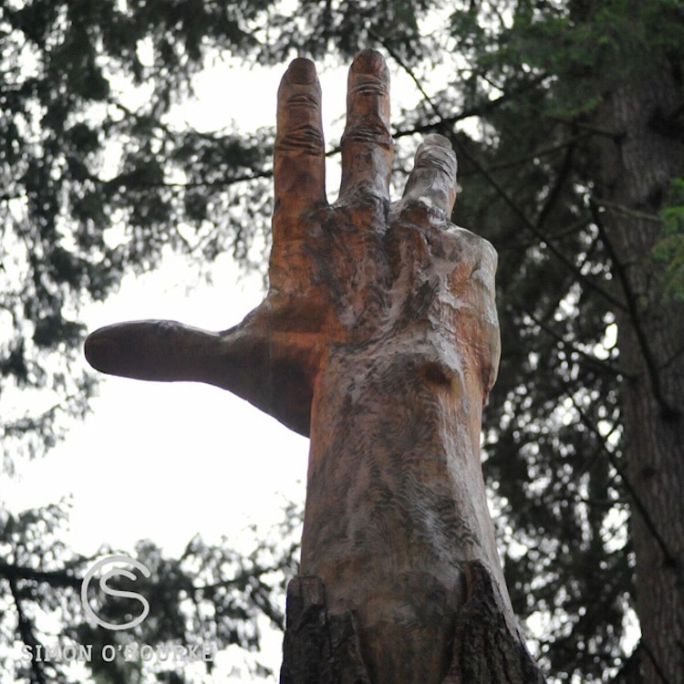 Escultura de una mano alzándose al cielo