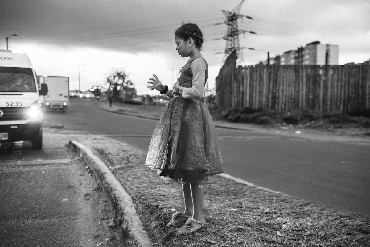 Young Girl Standing on the Side of the Road