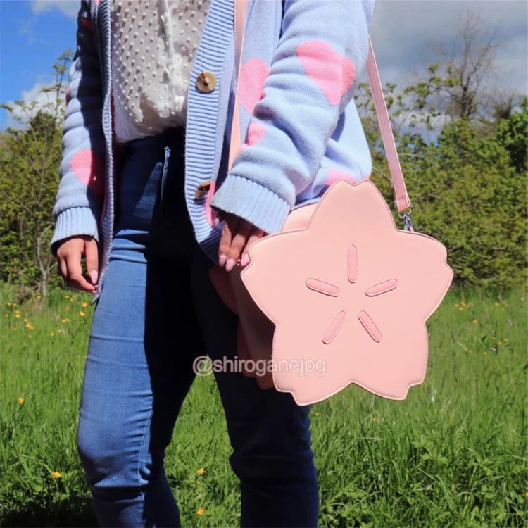 woman wearing pink cherry blossom crossbody bag