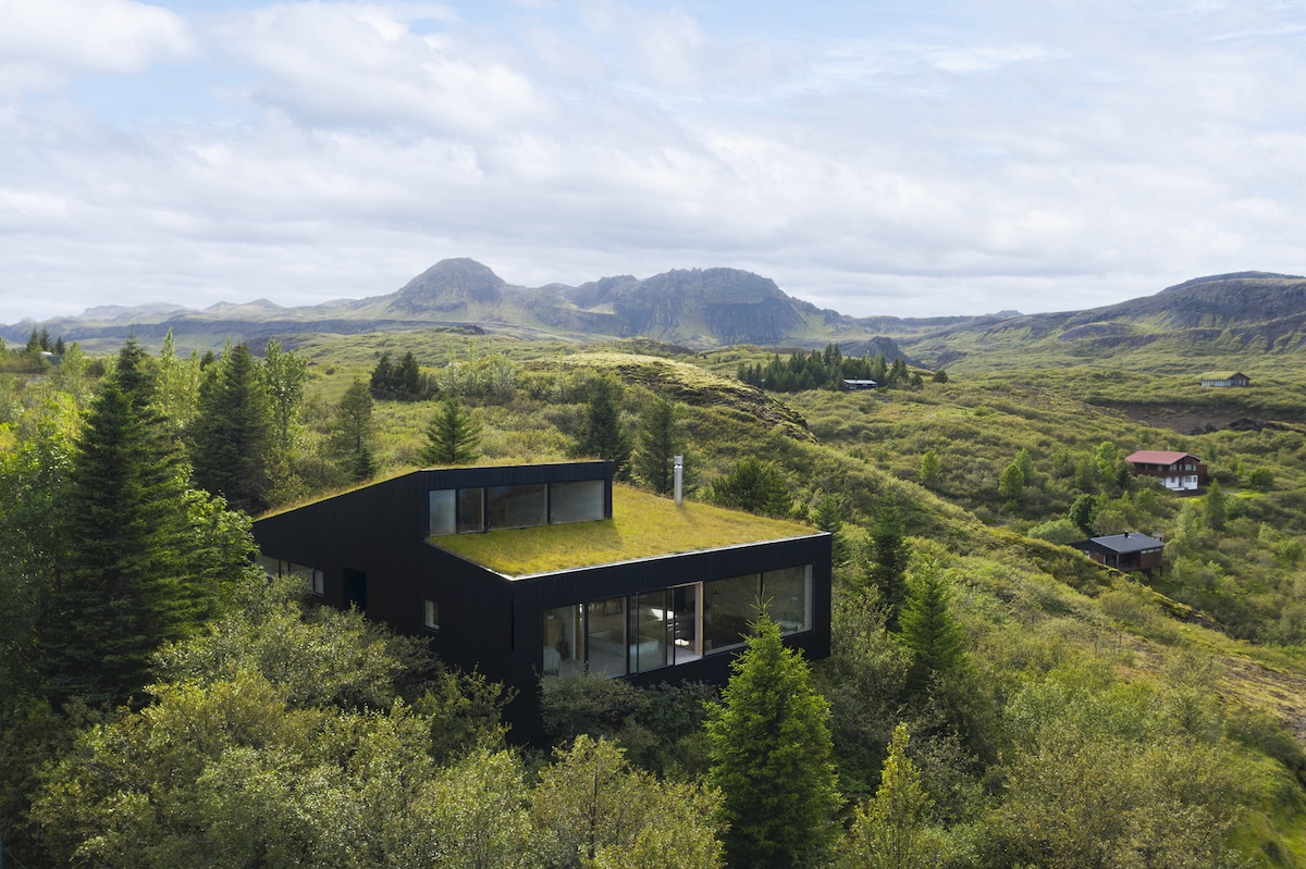 Casa verde en Islandia que se integra con las colinas que la rodean
