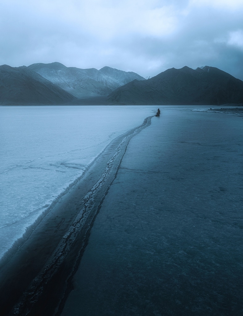 Someone all alone on the beach in winter