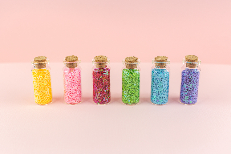 Small Jars With Colorful Sequins in Them