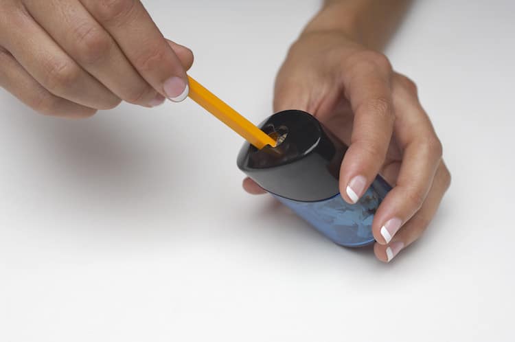 Person Sharpening a Pencil