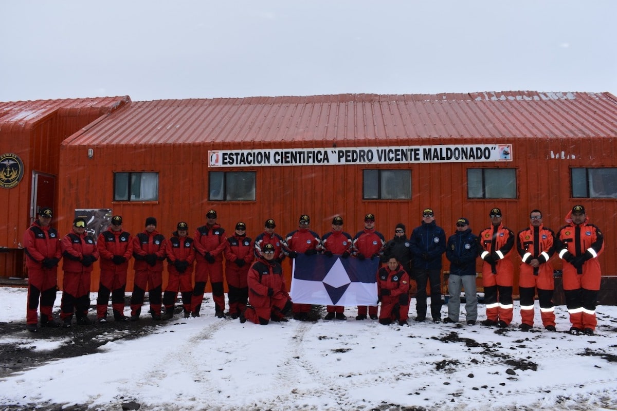 Members of Ecuador and Colombia's National Antarctic Programs with True South at Maldonado Base, Antarctica