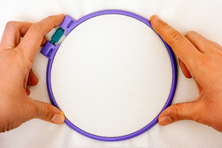 Person Tightening a Plastic Hoop
