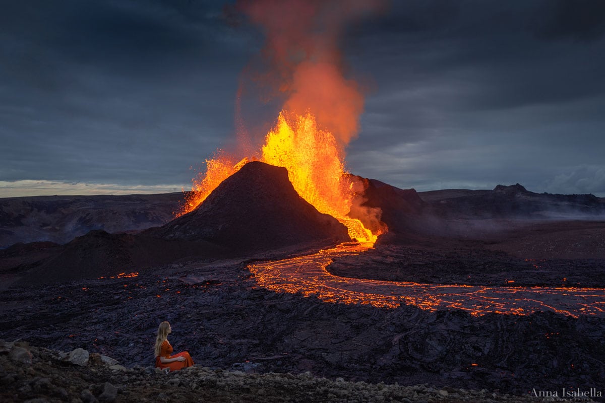 Fagradalsfjall Volcano Erupting with Woman Seated in the Foreground