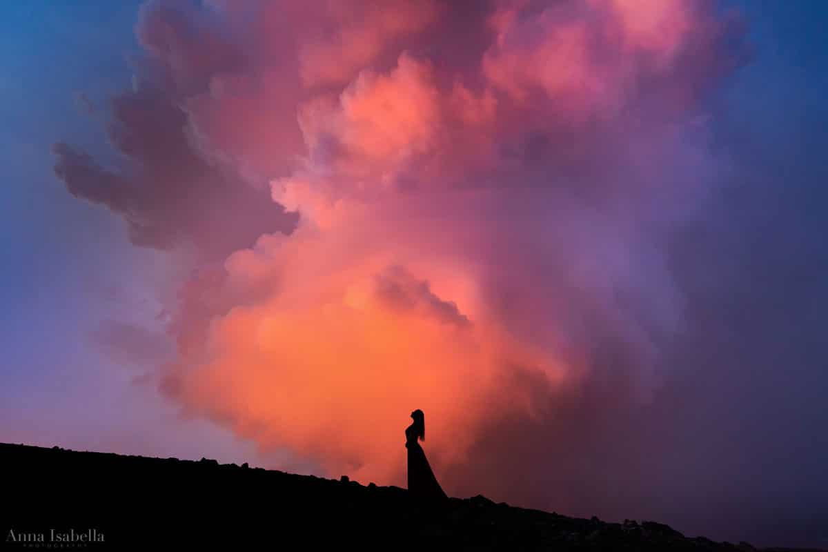 Woman Posing in front of Smoke From Erupting Volcano