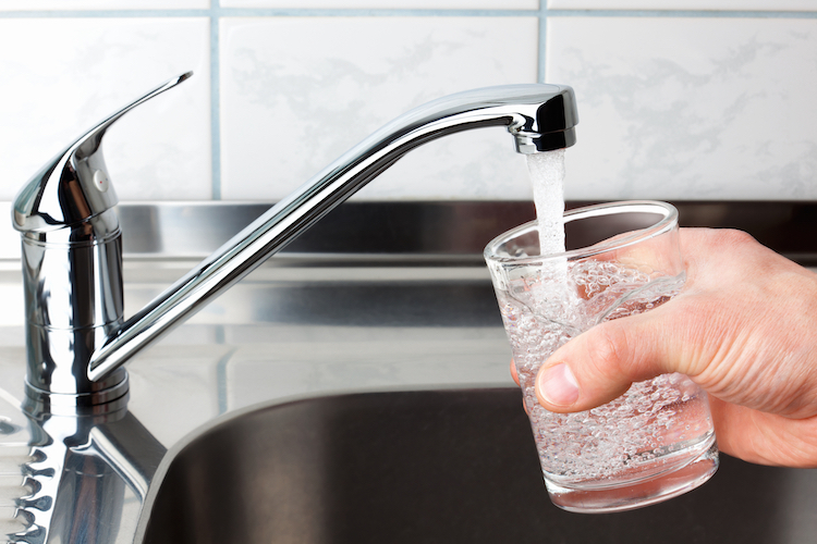 Glass filled with drinking water from kitchen faucet.