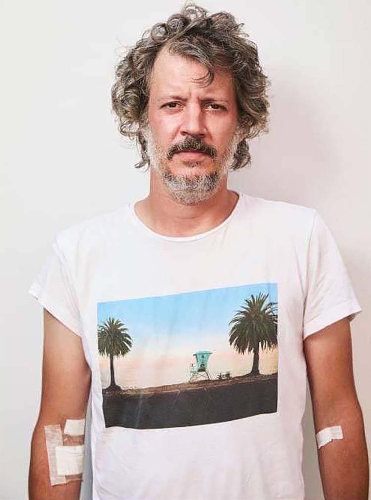 Portrait of Man With Curly Hair Wearing Palm Tree T-Shirt