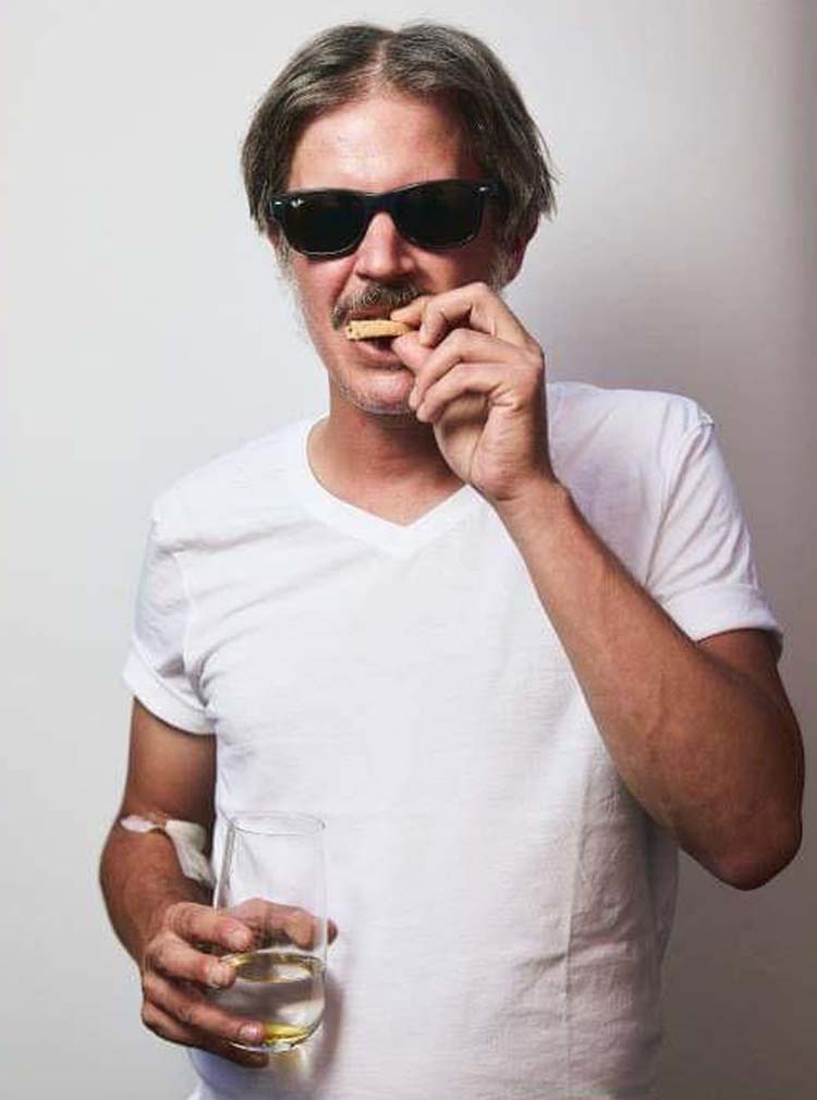 Man Wearing Sunglasses and Eating Cookies