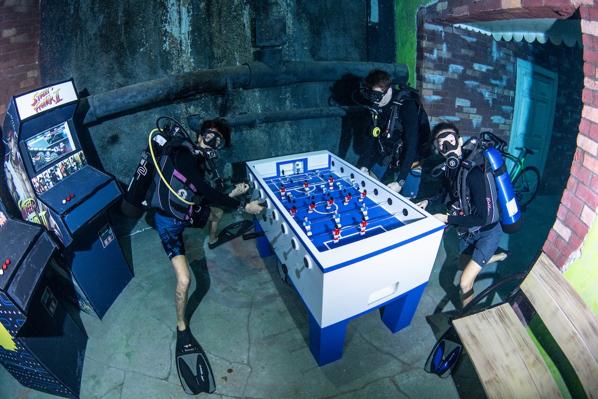 Divers Playing Foosball Underwater