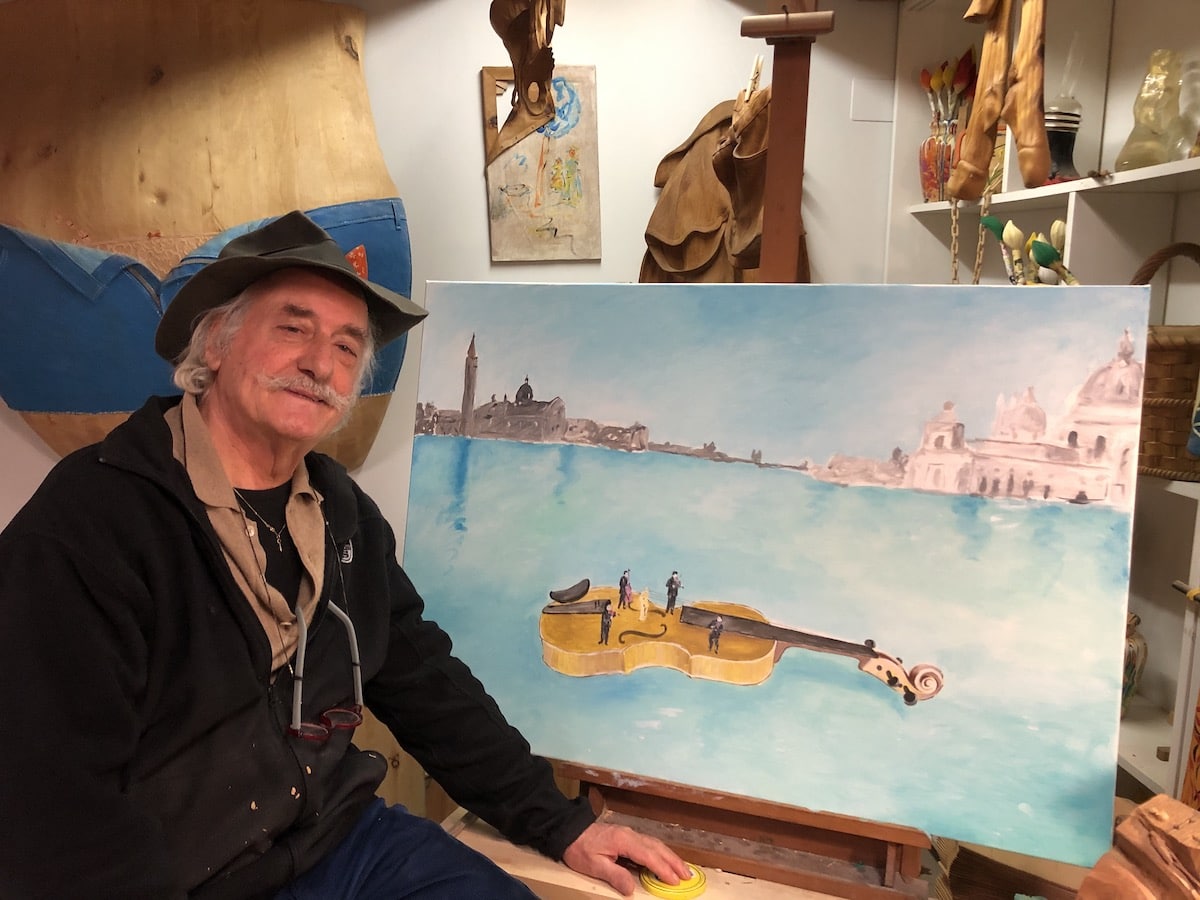 Livio de Marchi with His Painting of a Floating Violin