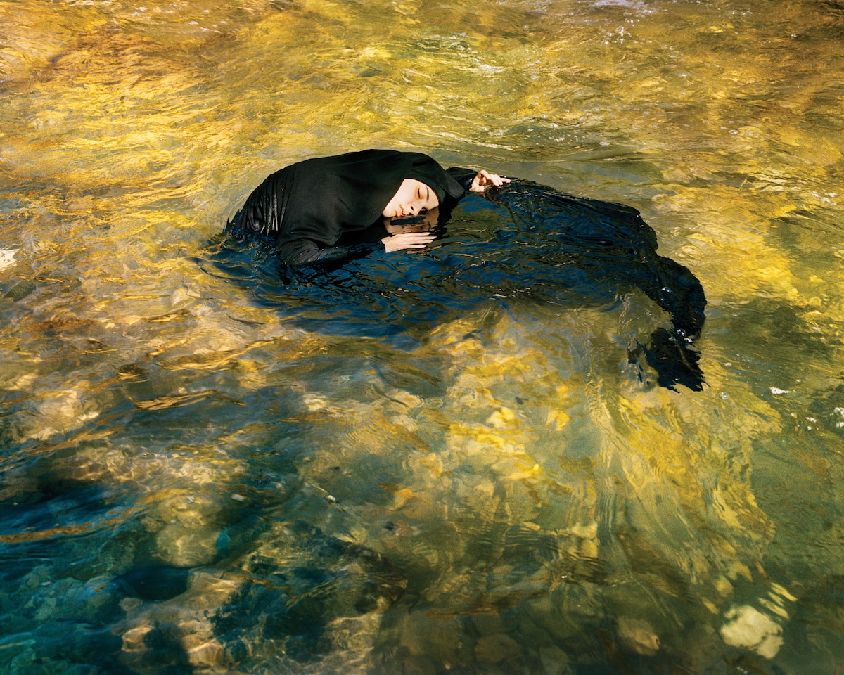 Woman in a Burqa Floating in Water