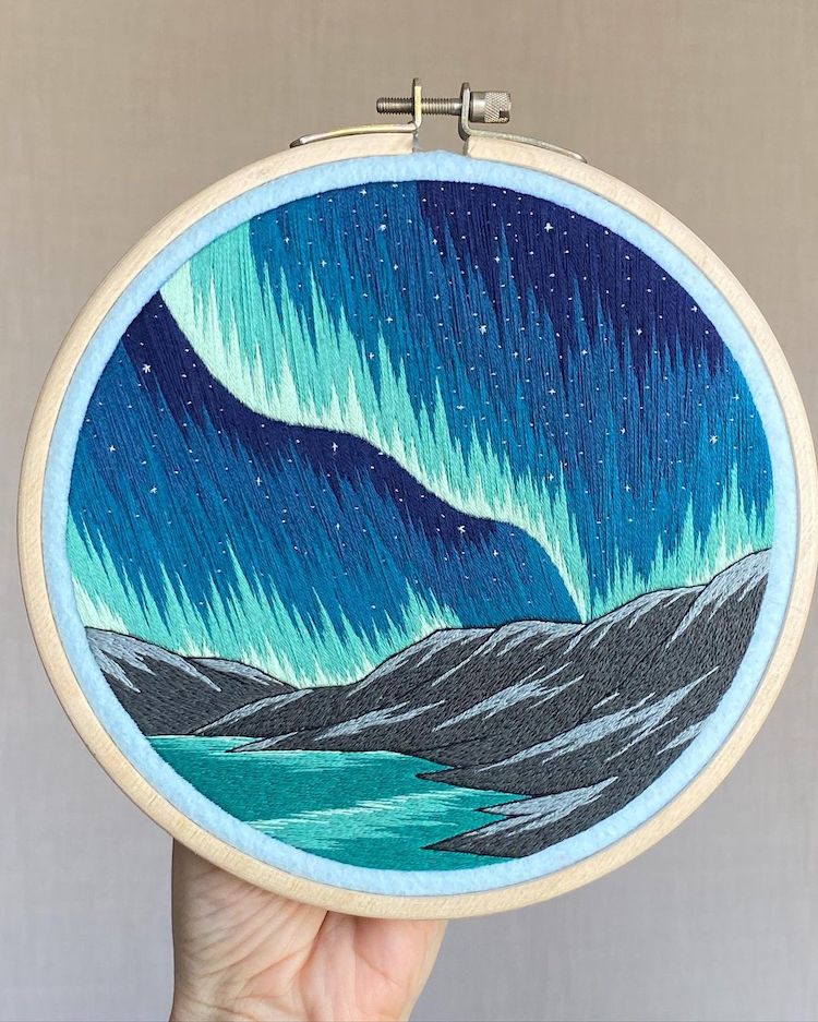 Hoop Art featuring the Northern Lights above the mountains