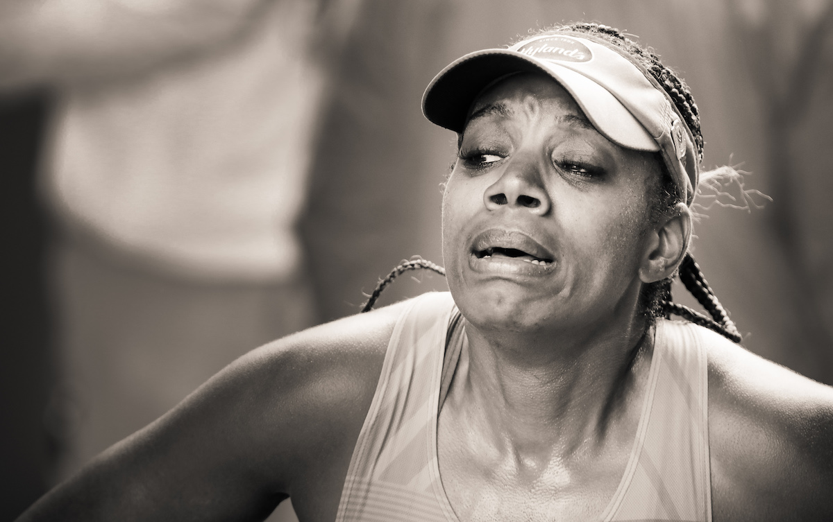 Woman Crossing Finish Line of the 2021 Boston Marathon by Ben Garvin