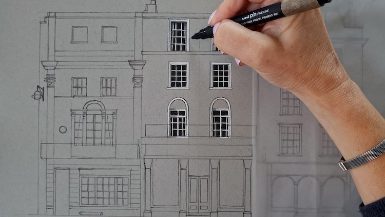 Demi Lang dessinant un bâtiment