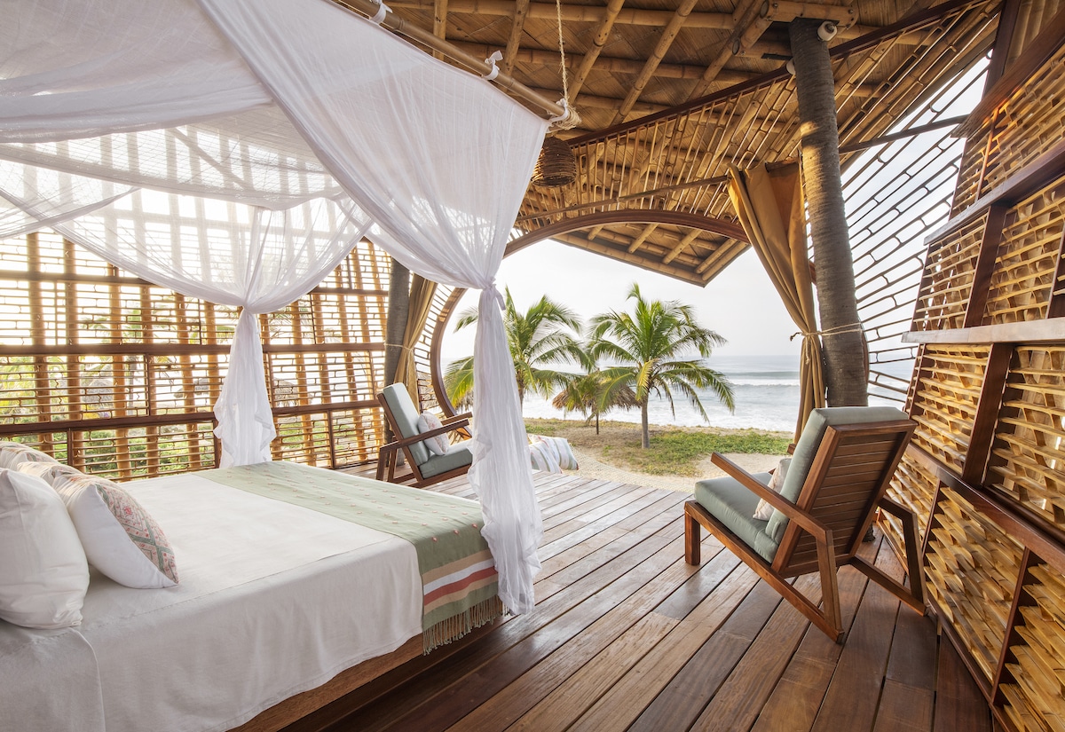 Bed in Bamboo Treehouses at Playa Viva by Atelier Nomadic
