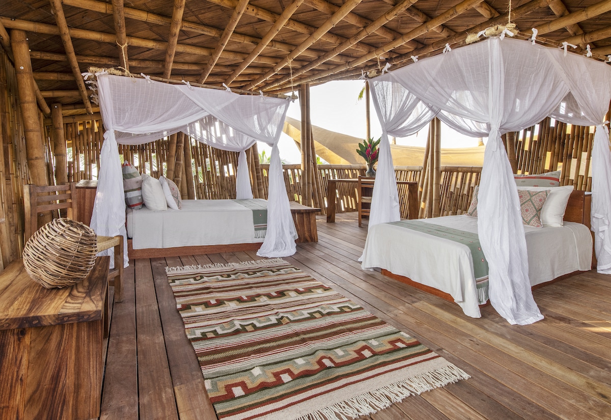 Bed in Bamboo Treehouses at Playa Viva by Atelier Nomadic