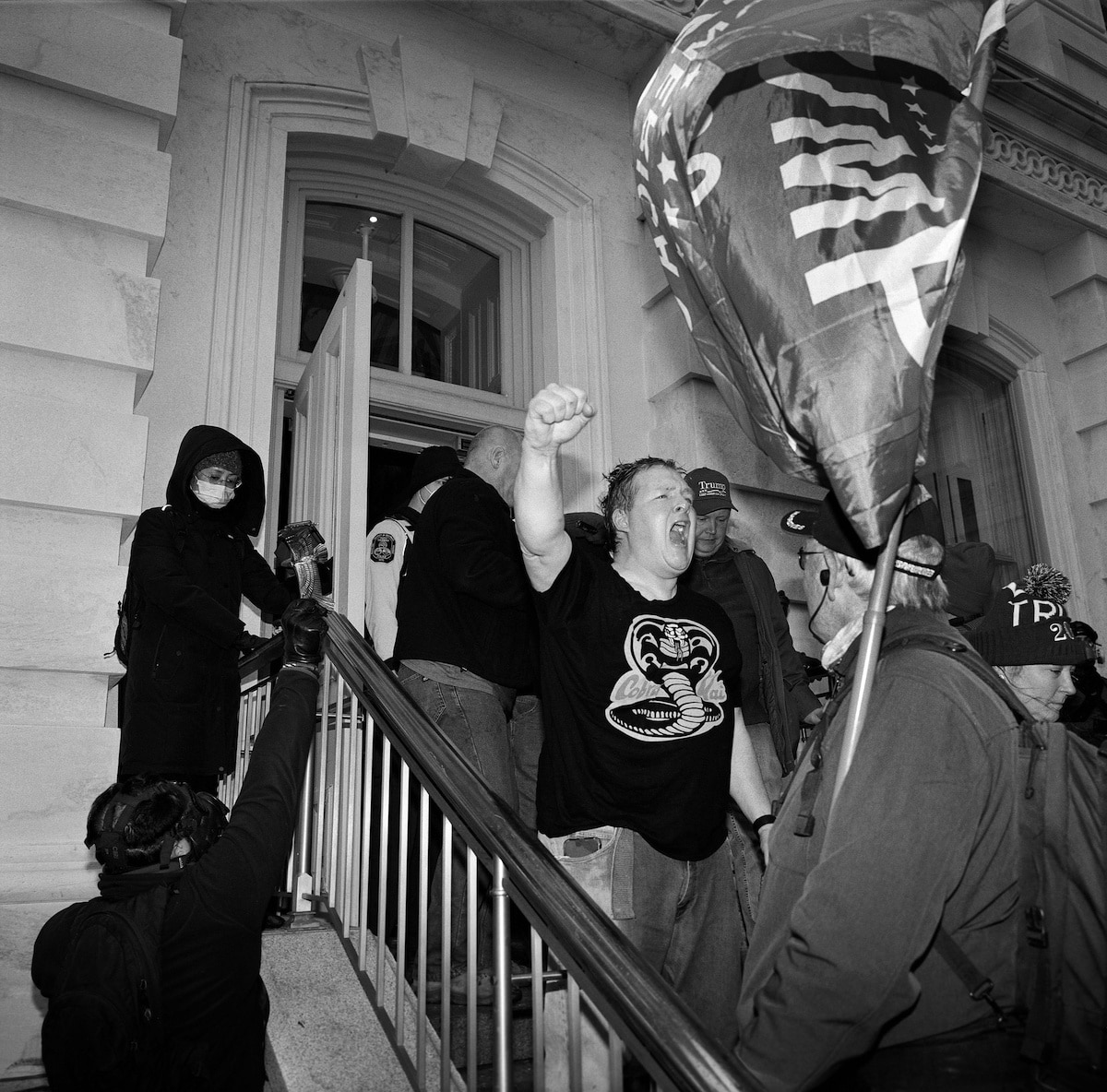 Trump supporter pumps his fist as he is ejected from the Capitol Building After January 6 Riot